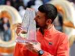 Serbia's Novak Djokovic celebrates with the trophy after winning the final match against Poland's Hubert Hurkacz, Novak Djokovic's 100th career ATP tour title
