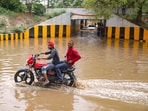 Men ride a motorcycle through a waterlogged area at Sector 146 on the Noida-Greater Noida Expressway following Wednesday's heavy rainfall. Men ride a motorcycle through a waterlogged area at Sector 146 on the Noida-Greater Noida Expressway following Wednesday's heavy rainfall.