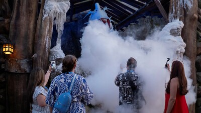 Attendees interact with the animatronic Snow Dragon at "How to Train Your Dragon - Isle of Berk" world in Universal Epic Universe theme park ahead of the grand opening celebration in Orlando, Florida, U.S. May 21, 2025. REUTERS/Marco Bello (REUTERS)