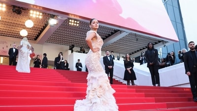 Alia Bhatt's off-shoulder gown featured intricate floral embroidery, organza work and ivory ruffles. (Photo by Valery HACHE / AFP) (AFP) Alia Bhatt's off-shoulder gown featured intricate floral embroidery, organza work and ivory ruffles. (Photo by Valery HACHE / AFP) (AFP)