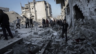 Residents amongst building rubble following an Israeli airstrike at a refugee camp in Jabaliya, northern Gaza, on Friday. (Bloomberg) Residents amongst building rubble following an Israeli airstrike at a refugee camp in Jabaliya, northern Gaza, on Friday. (Bloomberg)