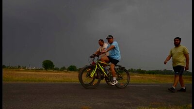 Residents enjoying cycling moments before a thunderstorm hit the city, bringing relief from heat on Saturday. (Gurpreet Singh/HT) Residents enjoying cycling moments before a thunderstorm hit the city, bringing relief from heat on Saturday. (Gurpreet Singh/HT)