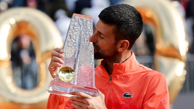 Serbia's Novak Djokovic celebrates with the trophy after winning the final match against Poland's Hubert Hurkacz, Novak Djokovic's 100th career ATP tour title (REUTERS)