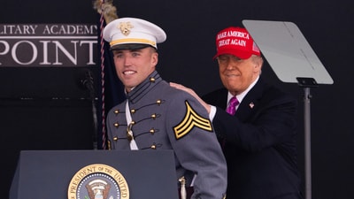 President Donald Trump pats graduating cadet Bryson Daily on the back, who is an American college football quarterback for the Army Black Knights, during the United States Military Academy commencement ceremonies in West Point, N.Y., Saturday, May 24, 2025. (AP Photo/Adam Gray) (AP)