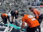 Rescuers place a casualty to transport them on a stretcher, in Khan Younis, Gaza, May 23, 2025.