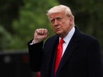 U.S. President Donald Trump raises a fist as he departs the White House to attend his meme coin gala at the Trump National Golf Club, in Washington, D.C., U.S., May 22, 2025. REUTERS/Evelyn Hockstein