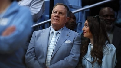 North Carolina Tar Heels football head coach Bill Belichick and his girlfriend Jordon Hudson look on during the first half of the game between the North Carolina Tar Heels and the Duke Blue Devils at Dean E. Smith Centre on March 08, 2025, in Chapel Hill, North Carolina. (Getty Images via AFP)