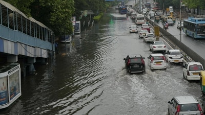 Vehicles move through a waterlogged road following rains, at ITO in New Delhi. (PTI) Vehicles move through a waterlogged road following rains, at ITO in New Delhi. (PTI)