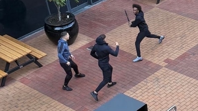 The unidentified man was seen charging with a machete at the Melbourne mall (Drew Pavlou/X) The unidentified man was seen charging with a machete at the Melbourne mall (Drew Pavlou/X)