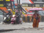 People make way through a waterlogged road at Gandhi Market amid heavy rains at Matunga in Mumbai, Monday, May 26, 2025. People make way through a waterlogged road at Gandhi Market amid heavy rains at Matunga in Mumbai, Monday, May 26, 2025.