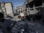 Residents and emergency service workers search the rubble following an Israeli airstrike at a refugee camp in Jabaliya, northern Gaza, on Friday, May 23, 2025. 