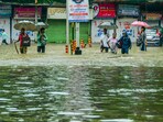 Pedestrians wade through an inundated road amid rains, in Mumbai, Monday, May 26, 2025. Pedestrians wade through an inundated road amid rains, in Mumbai, Monday, May 26, 2025.