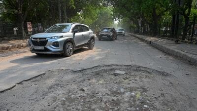 A pothole in the middle of the Sector-9/9A road in Gurugram on Monday. (Parveen Kumar/HT Photo)