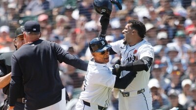 Javier Baez #28 (R) of the Detroit Tigers is held back by third base coach Joey Cora #56 after being called out on strikes as manager A.J. Hinch #14 argues with home plate umpire Phil Cuzzi in the fifth inning at Comerica Park on May 26, 2025 in Detroit, Michigan. (Getty Images via AFP)