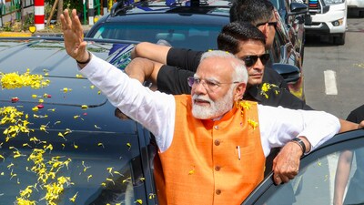 Prime Minister Narendra Modi waves at supporters during a roadshow in Vadodara, Gujarat, Monday (PTI) Prime Minister Narendra Modi waves at supporters during a roadshow in Vadodara, Gujarat, Monday (PTI)