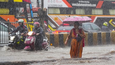 People make way through a waterlogged road at Gandhi Market amid heavy rains at Matunga in Mumbai, Monday, May 26, 2025. (PTI) People make way through a waterlogged road at Gandhi Market amid heavy rains at Matunga in Mumbai, Monday, May 26, 2025. (PTI)