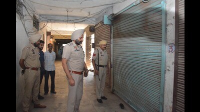 Police officials investigating the crime scene in Amritsar on Monday. (Sameer Sehgal/HT) Police officials investigating the crime scene in Amritsar on Monday. (Sameer Sehgal/HT)
