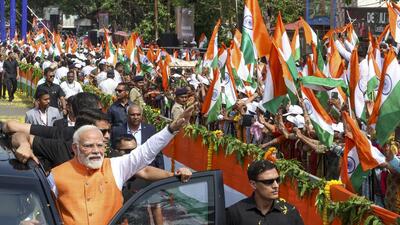 Prime Minister Narendra Modi waves at the gathering during a roadshow in Vadodara on Monday. (PMO) Prime Minister Narendra Modi waves at the gathering during a roadshow in Vadodara on Monday. (PMO)