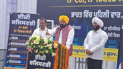 Punjab chief minister Bhagwant Mann launching the easy registry for property scheme in the presence of AAP national convener Arvind Kejriwal and MLA Kulwant Singh at the district administrative complex in Mohali on Monday. (Sanjeev Sharma/HT)