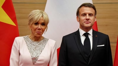 France's President Emmanuel Macron (R) poses with his wife Brigitte Macron during a state dinner with Vietnam's President Luong Cuong at the International Convention Center in Hanoi on May 26, 2025. (Photo by Ludovic MARIN / AFP) (AFP) France's President Emmanuel Macron (R) poses with his wife Brigitte Macron during a state dinner with Vietnam's President Luong Cuong at the International Convention Center in Hanoi on May 26, 2025. (Photo by Ludovic MARIN / AFP) (AFP)