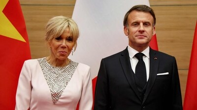 France's President Emmanuel Macron (R) poses with his wife Brigitte Macron during a state dinner with Vietnam's President Luong Cuong at the International Convention Center in Hanoi on May 26, 2025. (Photo by Ludovic MARIN / AFP) (AFP) France's President Emmanuel Macron (R) poses with his wife Brigitte Macron during a state dinner with Vietnam's President Luong Cuong at the International Convention Center in Hanoi on May 26, 2025. (Photo by Ludovic MARIN / AFP) (AFP)