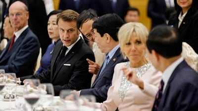 Vietnam's President Luong Cuong (3R) and his French counterpart Emmanuel Macron (3L) attend a state dinner with their respective wives Nguyen Thi Minh Nguyet (2L) and Brigitte Macron (2R) at the International Convention Center in Hanoi on May 26, 2025. (Photo by Ludovic MARIN / AFP) (AFP) Vietnam's President Luong Cuong (3R) and his French counterpart Emmanuel Macron (3L) attend a state dinner with their respective wives Nguyen Thi Minh Nguyet (2L) and Brigitte Macron (2R) at the International Convention Center in Hanoi on May 26, 2025. (Photo by Ludovic MARIN / AFP) (AFP)