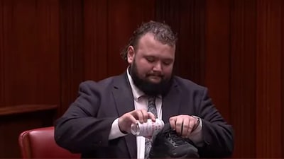 Australian MP Kyle McGinn downing a beer from his sneaker