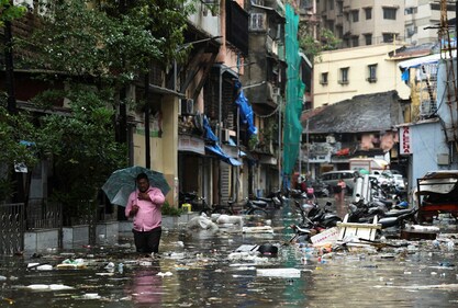 A man wades through a waterlogged street littered with garbage following heavy rainfall in Mumbai, India May 26, 2025. (REUTERS)