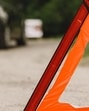 Driver putting warning triangle on asphalt road. Emergency stop concept. Driver putting warning triangle on asphalt road. Emergency stop concept.