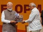 Gandhinagar: Prime Minister Narendra Modi being presented a memento by Gujarat chief minister Bhupendra Patel during an event.