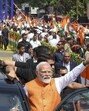 Prime Minister Narendra Modi waves at the gathering during a roadshow in Vadodara on Monday. (PMO) Prime Minister Narendra Modi waves at the gathering during a roadshow in Vadodara on Monday. (PMO)