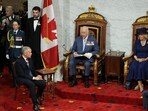 Queen Camilla and Prime Minister of Canada Mark Carney listen to King Charles III during his speech from the Throne, in the Senate Chamber at the Senate of Canada Building.