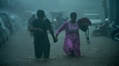 The torrential downpour caused major waterlogging at several places across Mumbai, prompting people to wade through knee-deep water filled on the roads. (ANI) The torrential downpour caused major waterlogging at several places across Mumbai, prompting people to wade through knee-deep water filled on the roads. (ANI)