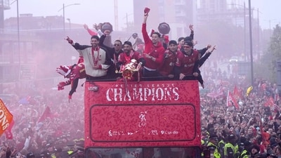 Liverpool players celebrate with the trophy on an open-top bus during the Liverpool FC Premier League victory parade in Liverpool, England, Monday, May 26, 2025. AP/PTI(AP05_27_2025_000078A) (AP) Liverpool players celebrate with the trophy on an open-top bus during the Liverpool FC Premier League victory parade in Liverpool, England, Monday, May 26, 2025. AP/PTI(AP05_27_2025_000078A) (AP)