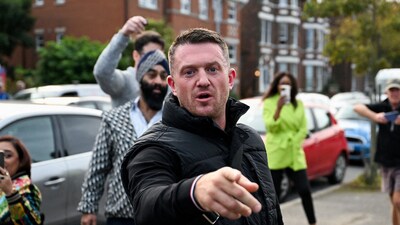FILE PHOTO: Anti-immigration activist Stephen Yaxley-Lennon, known as Tommy Robinson, gestures before arriving at Folkestone Police Station in Folkestone, Britain, October 25, 2024. REUTERS/Chris J Ratcliffe/File Photo (REUTERS)
