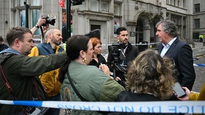 Mayor of Liverpool City Region, Steve Rotherham, talks to members of the media beside a police cordon on Water Street in Liverpool, north-west England on May 27, 2025, after a car ploughed in to crowds gathered to watch an open-top bus victory parade for Liverpool's Premier League trophy parade on May 26. Police said Monday they were not treating a Liverpool car ramming which left 27 people hospitalised as terrorism, after a vehicle ploughed into crowds celebrating Liverpool's Premier League football title. "We believe this to be an isolated incident, and we are not currently looking for anyone else in relation to it," Merseyside Police Assistant Chief Constable Jenny Sims told a press conference, adding a 53-year-old British man had been arrested. (Photo by Paul ELLIS / AFP) (AFP) Mayor of Liverpool City Region, Steve Rotherham, talks to members of the media beside a police cordon on Water Street in Liverpool, north-west England on May 27, 2025, after a car ploughed in to crowds gathered to watch an open-top bus victory parade for Liverpool's Premier League trophy parade on May 26. Police said Monday they were not treating a Liverpool car ramming which left 27 people hospitalised as terrorism, after a vehicle ploughed into crowds celebrating Liverpool's Premier League football title. "We believe this to be an isolated incident, and we are not currently looking for anyone else in relation to it," Merseyside Police Assistant Chief Constable Jenny Sims told a press conference, adding a 53-year-old British man had been arrested. (Photo by Paul ELLIS / AFP) (AFP)