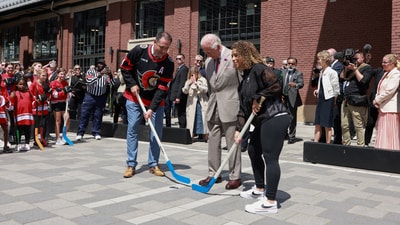 Britain's King Charles stands between Canadian ice hockey player Chris Phillips, and Canadian soccer player Desiree Scott, at Lansdowne Park, in Ottawa, Ontario, Canada, May 26, 2025. Ian Vogler/Pool via REUTERS (via REUTERS)