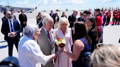 Britain's King Charles III and Britain's Queen Camilla receive flowers from Lila Graham, 14, of Carleton Place, Ontario, after they landed at Macdonald-Cartier International Airport in Ottawa, Canada, May 26, 2025, at the start of their two-day visit. (AFP) Britain's King Charles III and Britain's Queen Camilla receive flowers from Lila Graham, 14, of Carleton Place, Ontario, after they landed at Macdonald-Cartier International Airport in Ottawa, Canada, May 26, 2025, at the start of their two-day visit. (AFP)