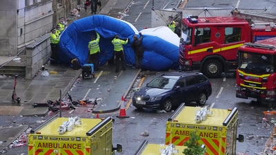 Police and emergency personnel deal with an incident after a car collided with pedestrians near the Liver Building during the Premier League winners parade in Liverpool, England, on Monday. (AP) Police and emergency personnel deal with an incident after a car collided with pedestrians near the Liver Building during the Premier League winners parade in Liverpool, England, on Monday. (AP)