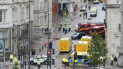 Police and emergency personnel work at the site of the incident where a car collided with pedestrians in Liverpool during the Premier League winners parade on Monday. (AP) Police and emergency personnel work at the site of the incident where a car collided with pedestrians in Liverpool during the Premier League winners parade on Monday. (AP)