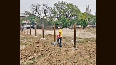 Fencing pillars being erected on the sports ground of Government College for Girls to turn it into a parking space for people visiting Shri Durga Mata Mandir in Ludhiana on Monday. (Gurpreet Singh/HT) Fencing pillars being erected on the sports ground of Government College for Girls to turn it into a parking space for people visiting Shri Durga Mata Mandir in Ludhiana on Monday. (Gurpreet Singh/HT)