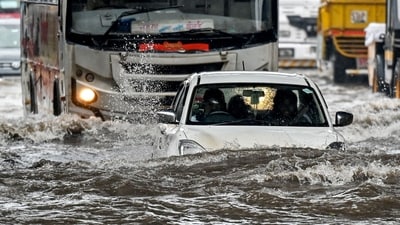 A car lies partially submerged as it wades through a flooded street after heavy rain showers in Mumbai on May 26, 2025. (AFP) A car lies partially submerged as it wades through a flooded street after heavy rain showers in Mumbai on May 26, 2025. (AFP)