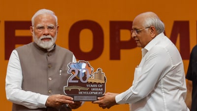Gandhinagar: Prime Minister Narendra Modi being presented a memento by Gujarat chief minister Bhupendra Patel during an event. (PTI) Gandhinagar: Prime Minister Narendra Modi being presented a memento by Gujarat chief minister Bhupendra Patel during an event. (PTI)