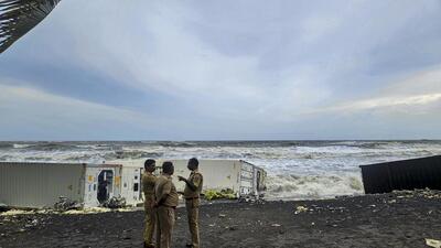 Security officials stand near containers from the Liberian cargo ship MSC ELSA 3, which sank off the Kochi coast (PTI) Security officials stand near containers from the Liberian cargo ship MSC ELSA 3, which sank off the Kochi coast (PTI)