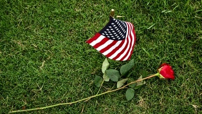 An American flag and a rose are seen at the Houston National Cemetery on Memorial day, in Houston, Texas, on May 26, 2025. (Photo by RONALDO SCHEMIDT / AFP) (AFP) An American flag and a rose are seen at the Houston National Cemetery on Memorial day, in Houston, Texas, on May 26, 2025. (Photo by RONALDO SCHEMIDT / AFP) (AFP)