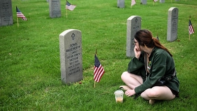 A woman visits a grave at the Houston National Cemetery on Memorial day, in Houston, Texas, on May 26, 2025. (Photo by RONALDO SCHEMIDT / AFP) (AFP) A woman visits a grave at the Houston National Cemetery on Memorial day, in Houston, Texas, on May 26, 2025. (Photo by RONALDO SCHEMIDT / AFP) (AFP)