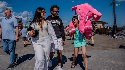 A family walks along the boardwalk at Coney Island Beach on Memorial Day in the Brooklyn borough of New York City, U.S., May 26, 2025. REUTERS/Angelina Katsanis (REUTERS)