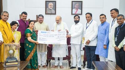 Union Home Minister Amit Shah presents a cheque to Swatantryaveer Savarkar Pratishthan's Ranjit Savarkar and Asholt Raje during 'Chhatrapati Sambhaji Maharaj Inspirational Song Award 2025' presentation for song "Anadi Mee.. Anant Mee ..." written by Swatantryaveer Vinayak Damodar Savarkar, at Varsha, official residence of the Chief Minister Devendra Fadnavis in Mumbai on Tuesday. State Deputy Chief Minister Eknath Shinde and others also seen. (ANI)