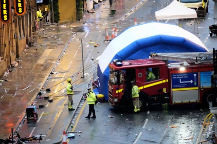 Police and emergency personnel walk next to a tent at the site of an incident on Water Street near the Liver Building in Liverpool after a car collided with pedestrians during the Premier League winners parade, in Liverpool, England, (AP) Police and emergency personnel walk next to a tent at the site of an incident on Water Street near the Liver Building in Liverpool after a car collided with pedestrians during the Premier League winners parade, in Liverpool, England, (AP)