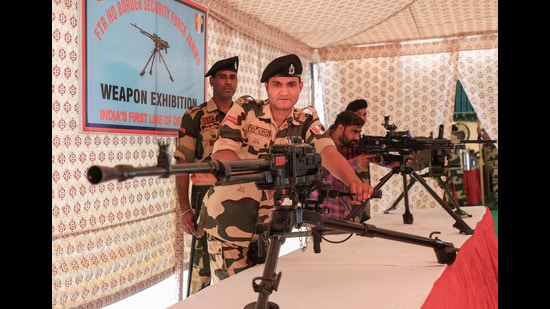 BSF personnel display weapons during an exhibition organised as part of their preparedness, at BSF Camp Paloura in Jammu. (PTI)